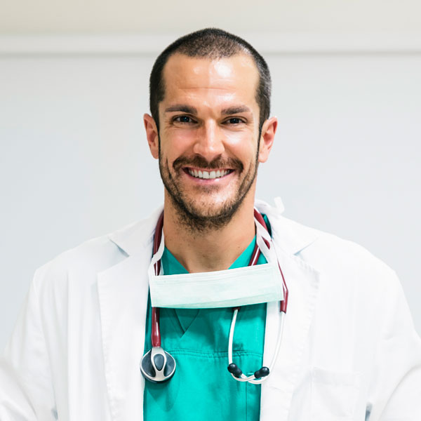 Smiling handsome doctor at hospital standing 6FH6KQ9
