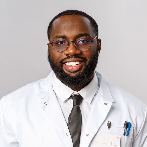 Young african american doctor on grey KAMDUJ6